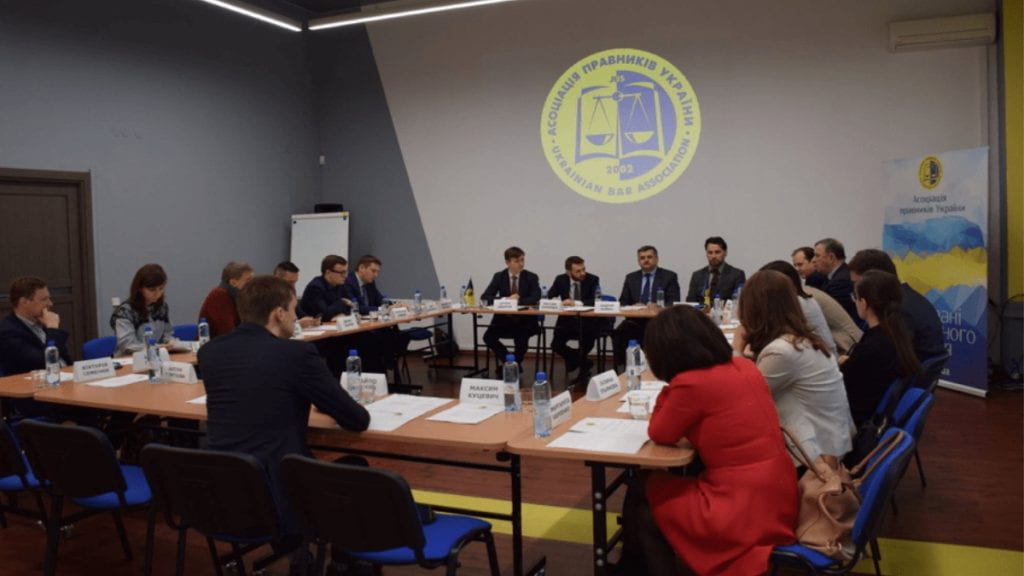 Group of people sitting at a roundtable discussing legal education in Ukraine