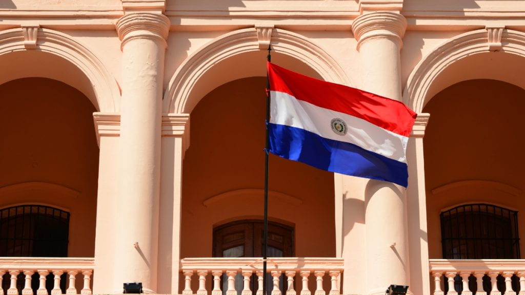 Paraguay flag flying in front of a building