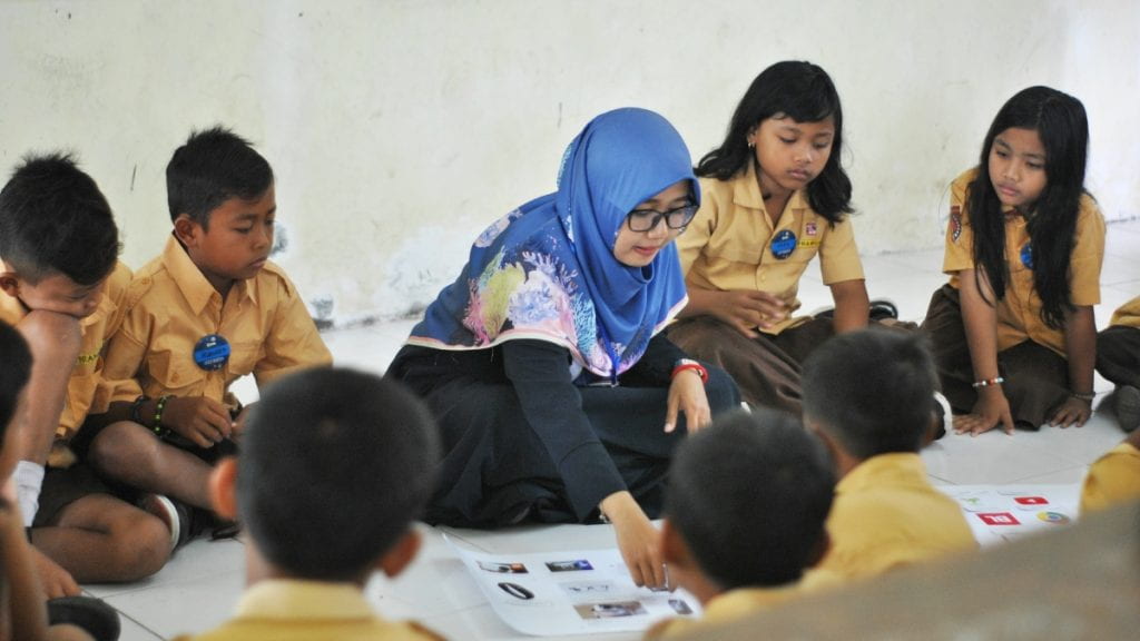 A teacher with students in Indonesia