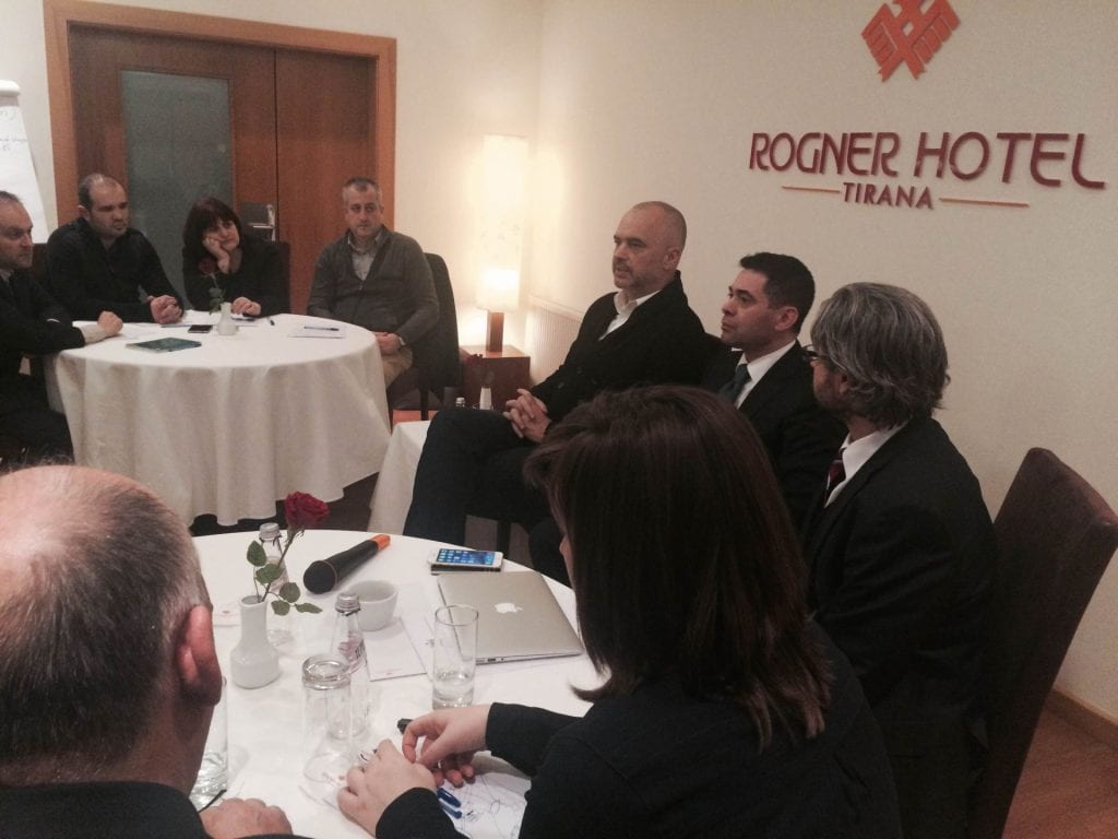 Matt Andrews seated at a table with other participants at the Rogner Hotel, Tirana