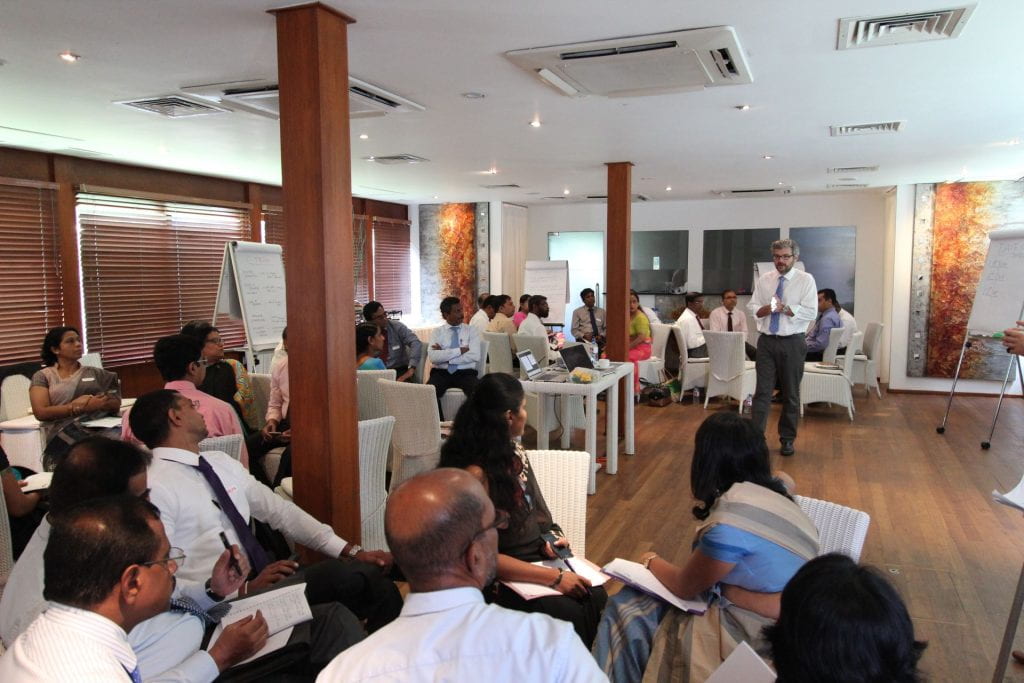 Matt Andrews presenting with Sri Lankan groups organized in circles