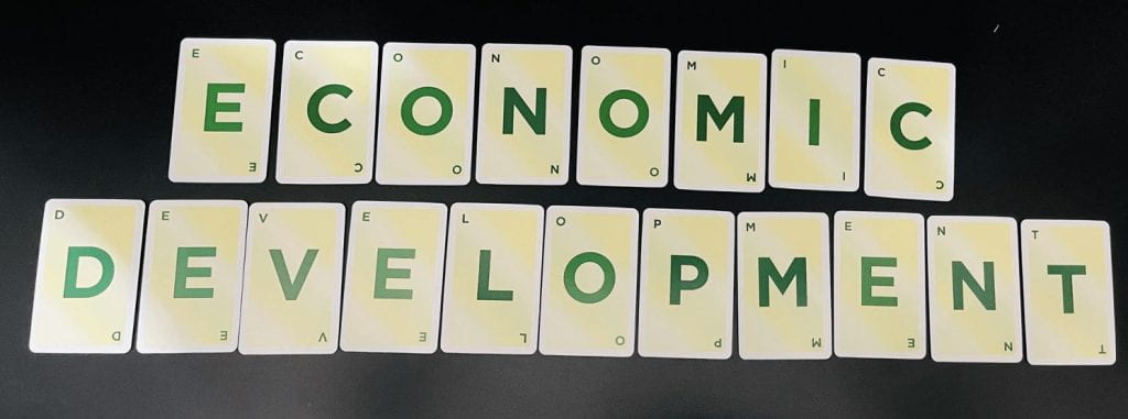 Playing cards of letters spelling Economic Development