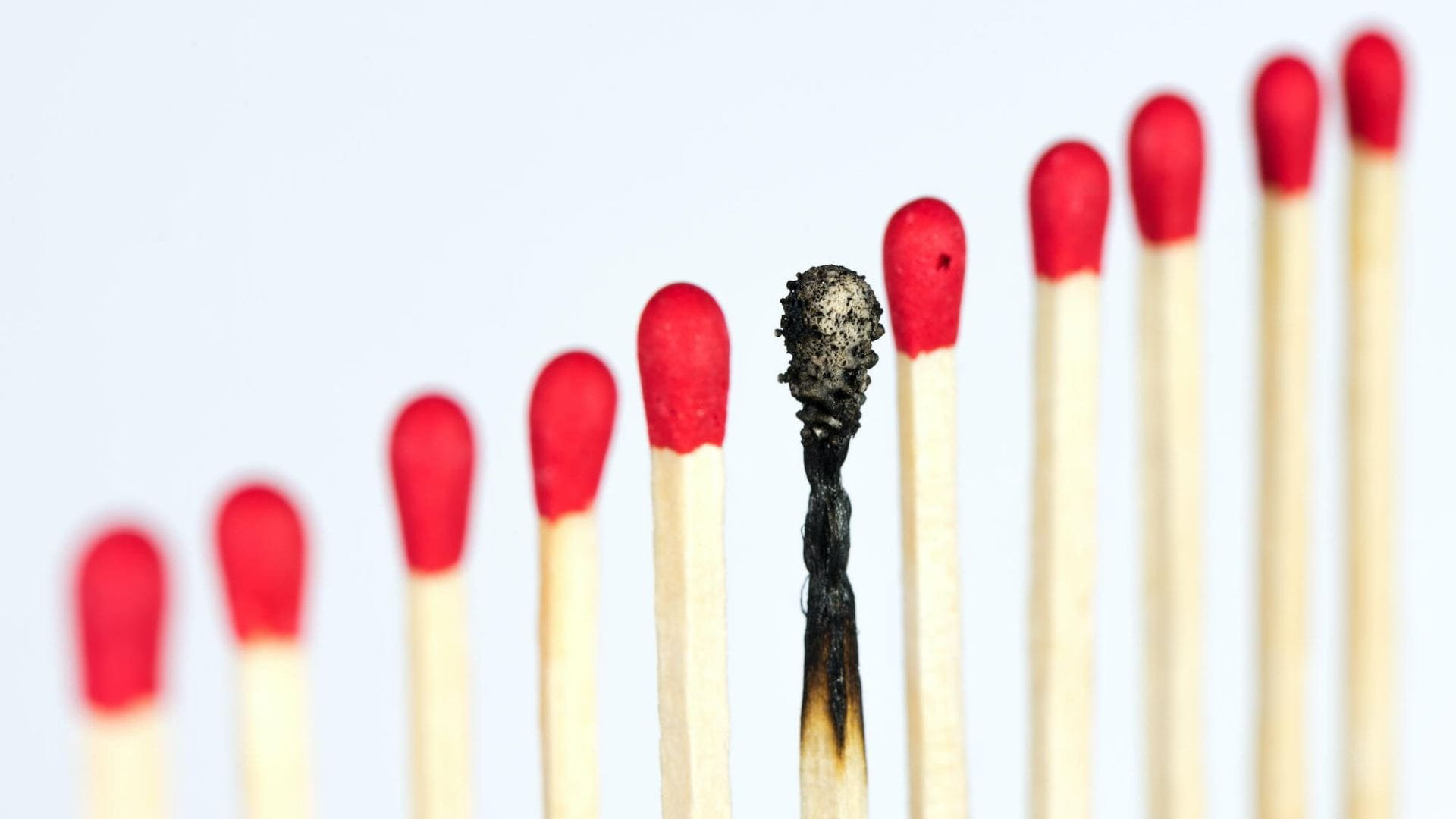 A set of matches with the middle match burned