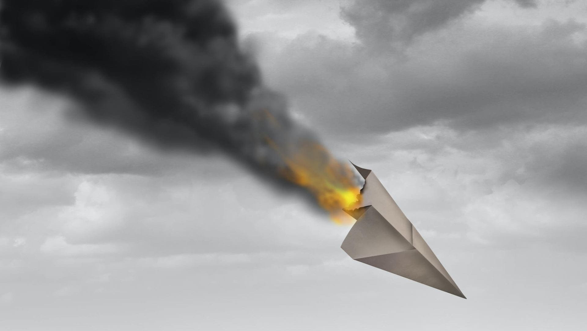 A paper airplane on fire and falling