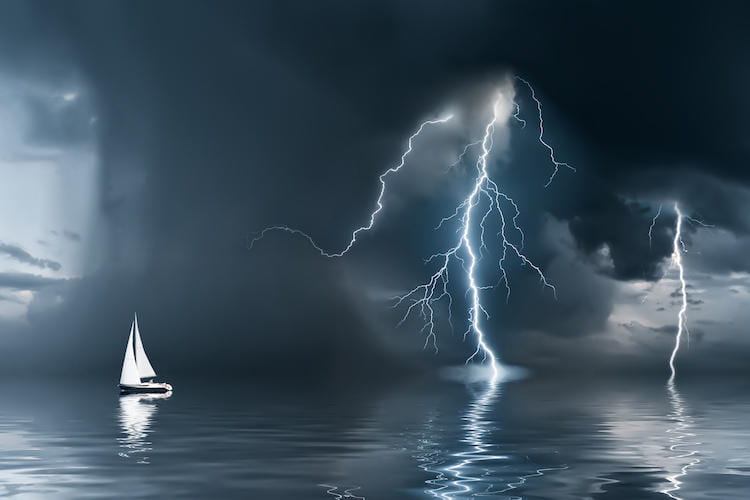 Sailboat with lightning and dark clouds approaching
