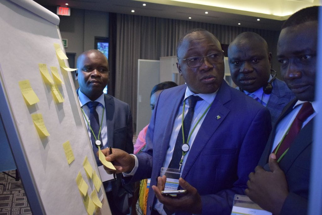Central African Republic team working together and using sticky notes on a whiteboard