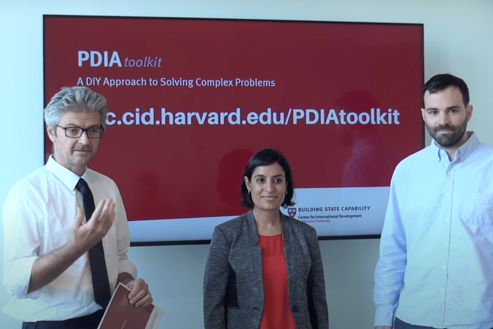Matt Andrews, Salimah Samji, and Tim McNaught presenting the new PDIA toolkit with slide of toolkit behind them