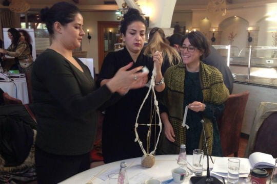 Albania participants working together to build a structure out of tape