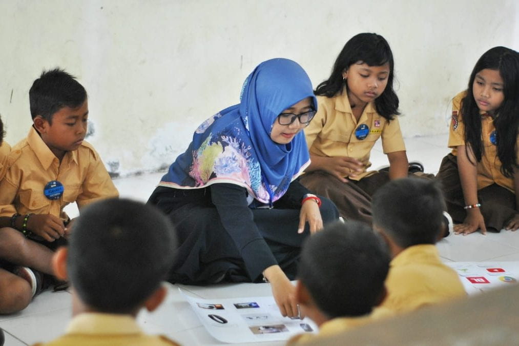 A teacher with students in Indonesia