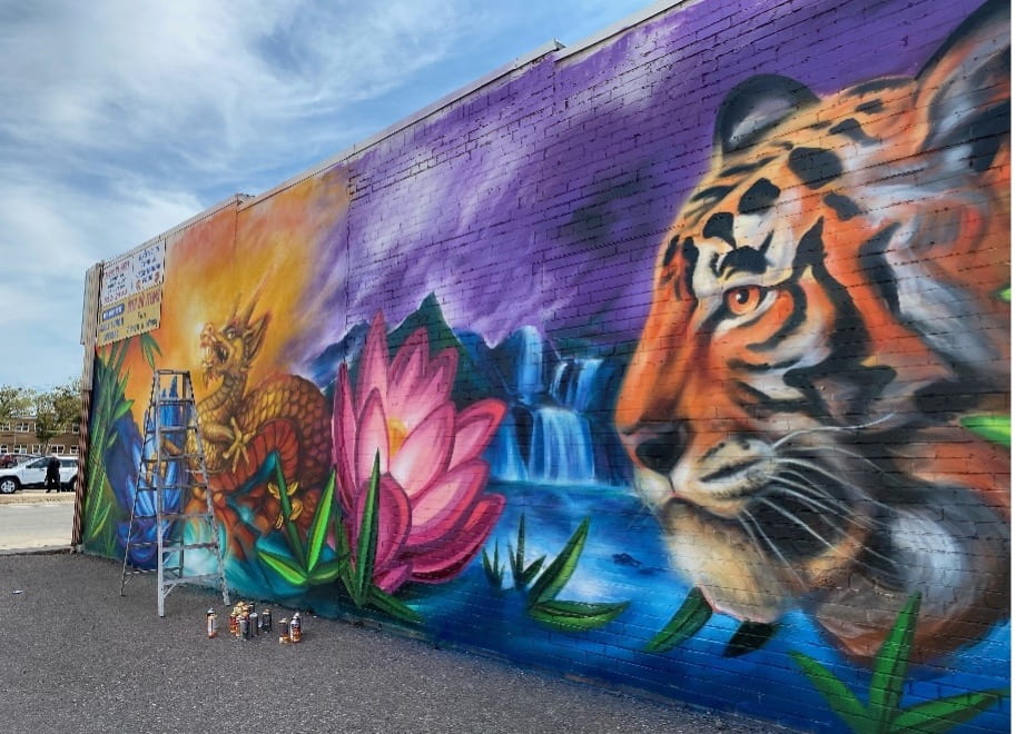 An outdoor mural with a dragon and tiger