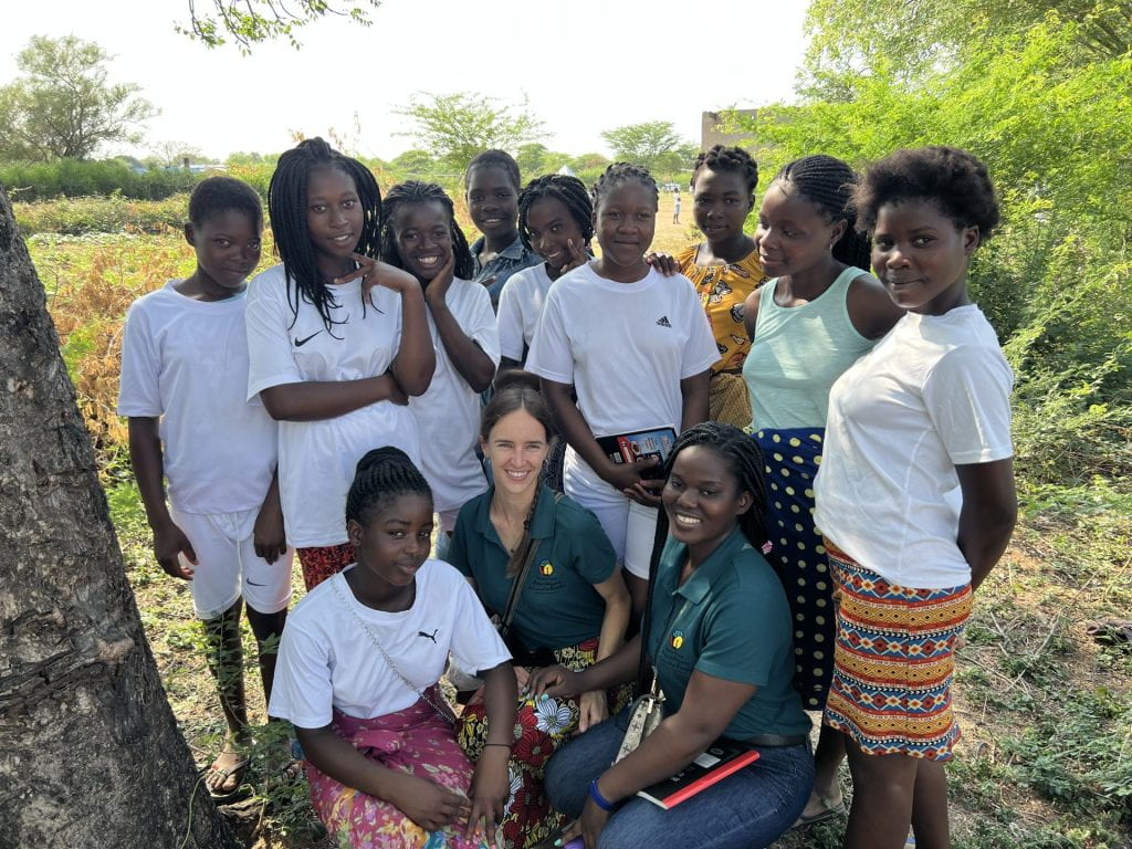 Cara Myers with students and other employees in Mozambique