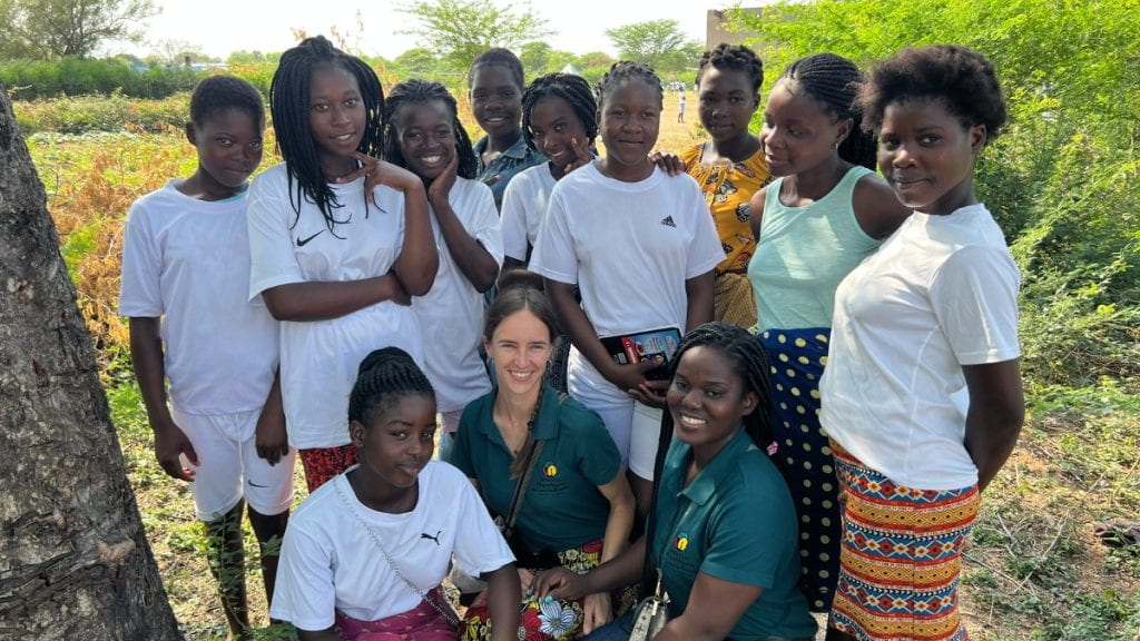Cara Myers with students and other employees in Mozambique