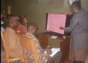 a group working in front of a pink chart paper