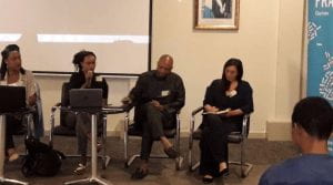 a panel seated in front of the room