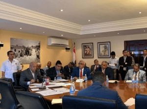 a group of men around a table in a meeting