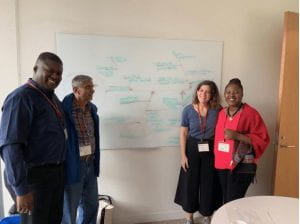 a group photograph in front of a white board