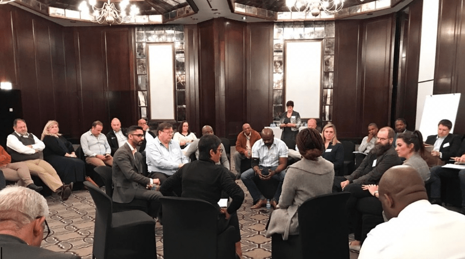 Conference room of people congregated in a circle