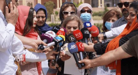 Image of woman being interviewd by media.