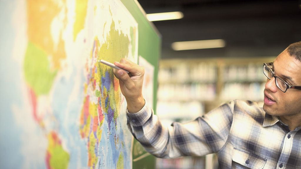 Person pointing on a map
