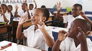 Kids showing hands during a lesson at an elementary school