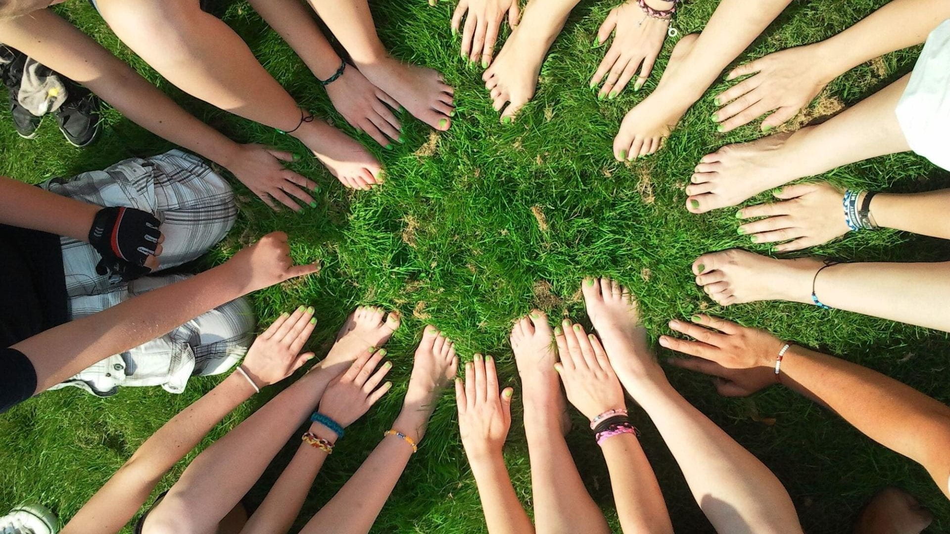 Arms and legs outstretched toward center, depicting teamwork