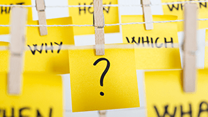 Sticky notes with a question mark and the words "Why" "Which" "How" "When" "What"
