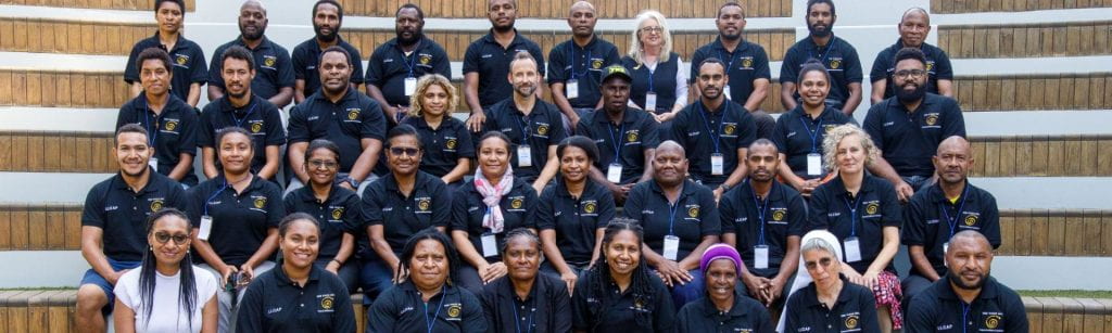 Papua New Guinea group photo of participants sitting on stairs