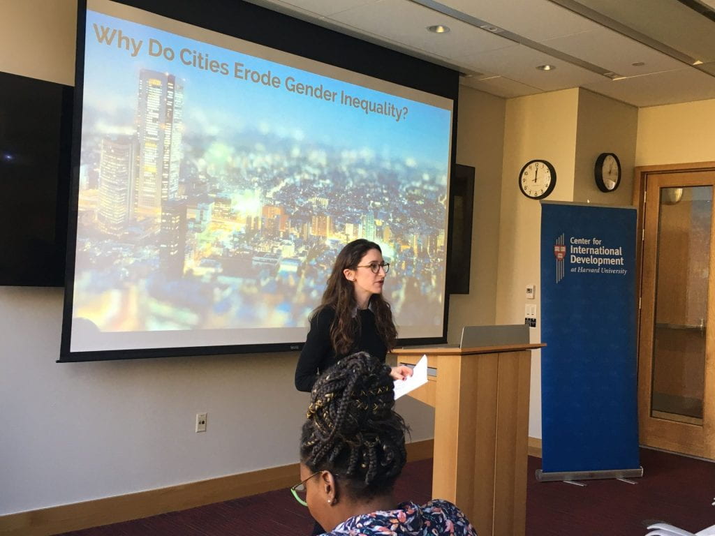 Marla Spivack presenting with slides behind her that say "Why do cities erode gender inequality"