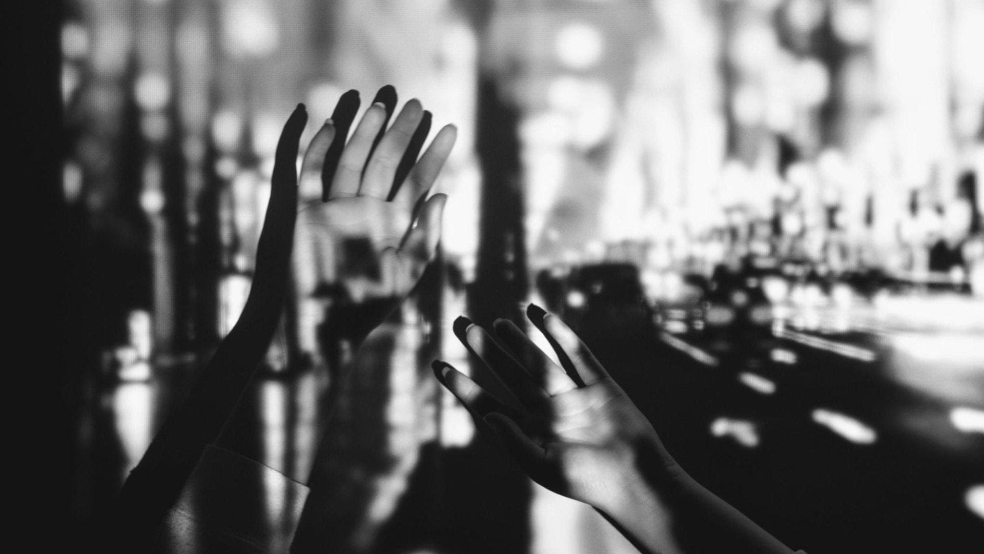 An abstract image of two hands with light and shadows projected