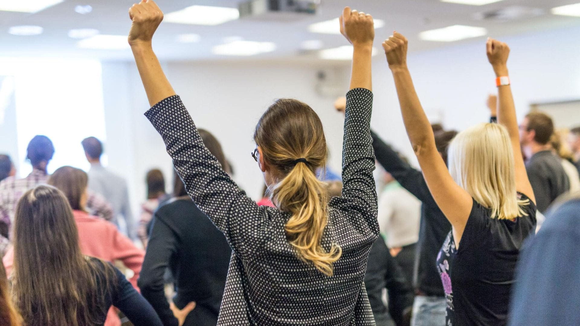 People celebrating with arms in the air