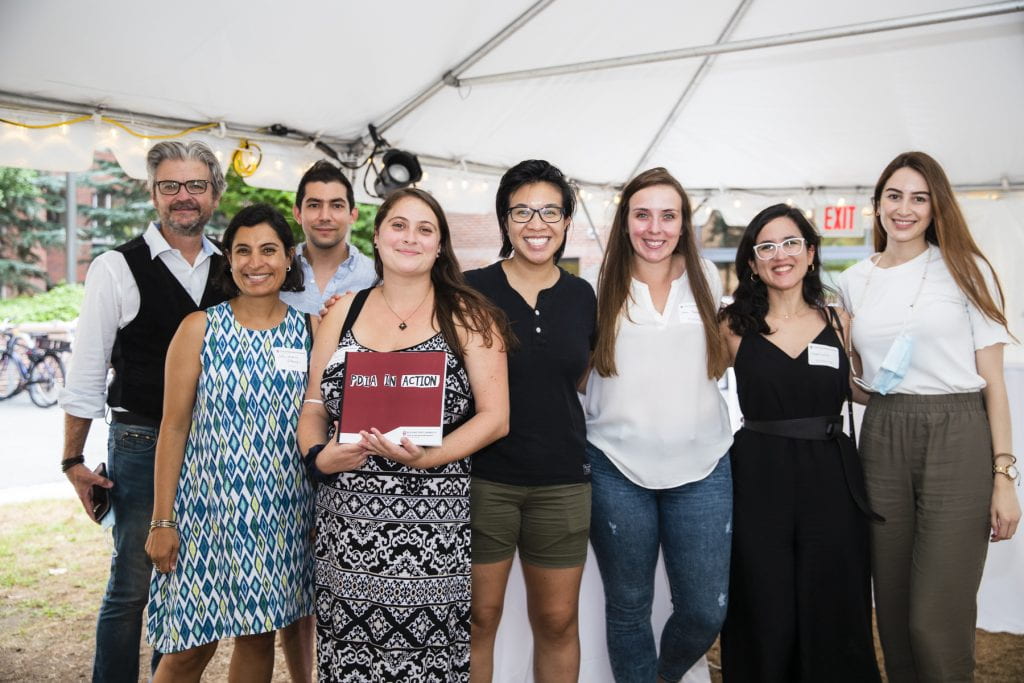 Group BSC photo with one person holding the PDIA in Action book