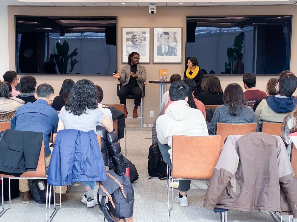 Daniel Agbiboa and Salimah Samji seated and presenting in front of students