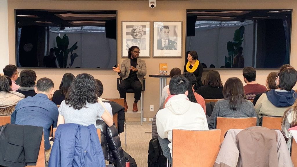 Daniel Agbiboa and Salimah Samji seated in the front of Malkin Penthouse speaking to a group of seated students
