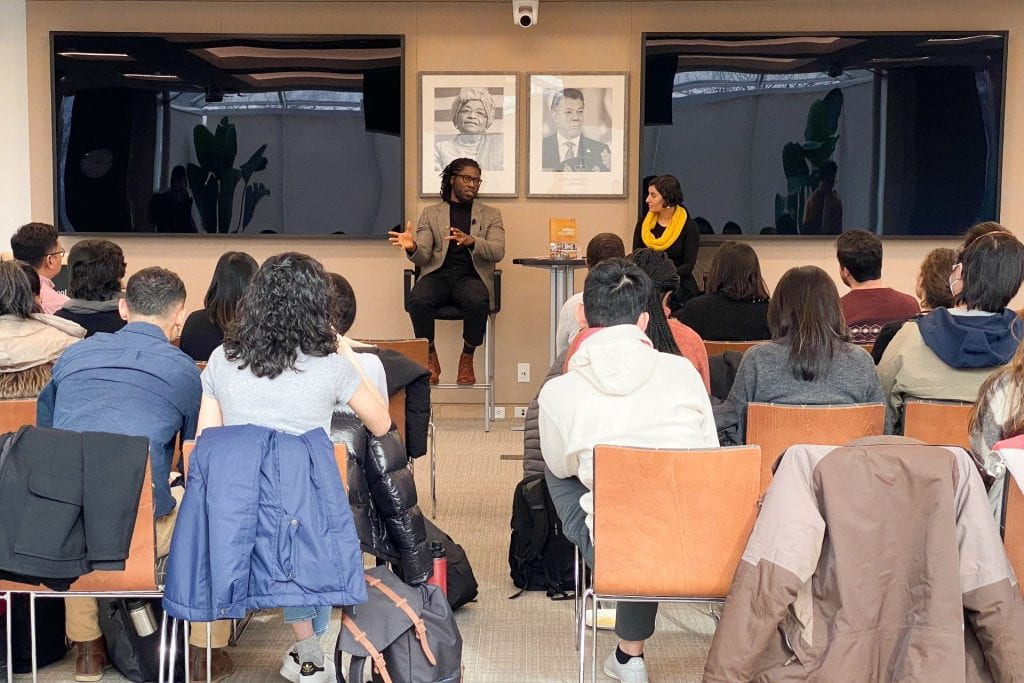 Daniel Agbiboa and Salimah Samji seated in the front of Malkin Penthouse speaking to a group of seated students