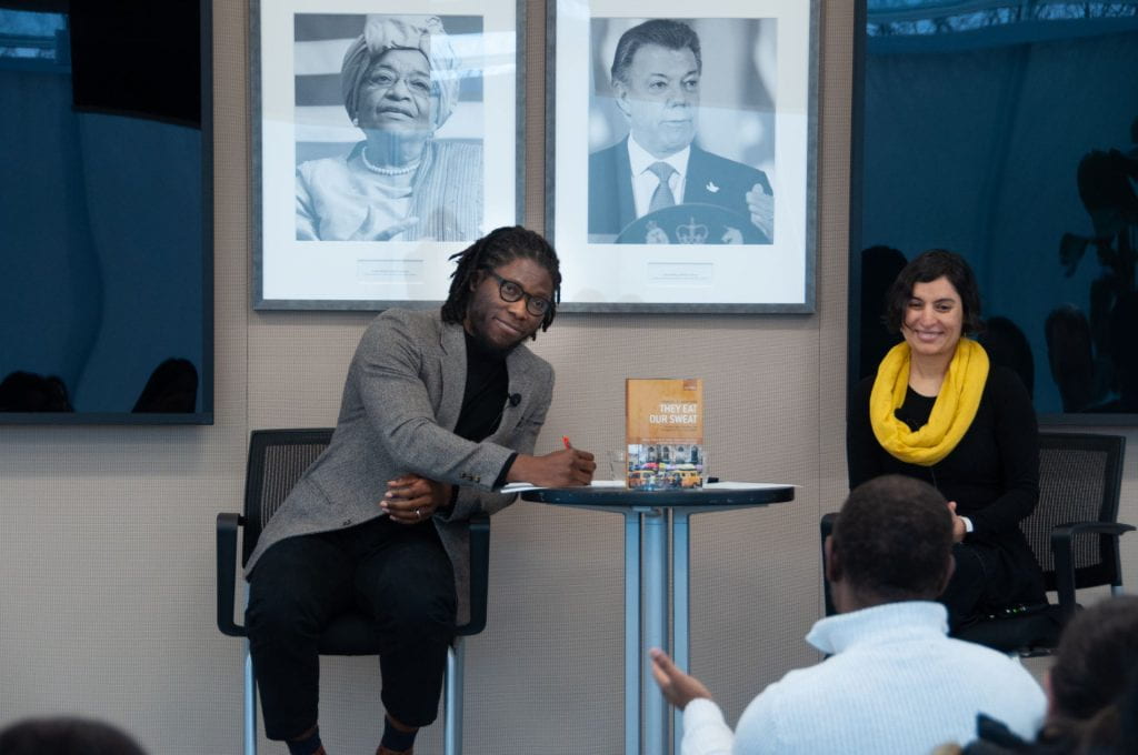 Daniel Agbiboa taking notes as an audience member asks a question