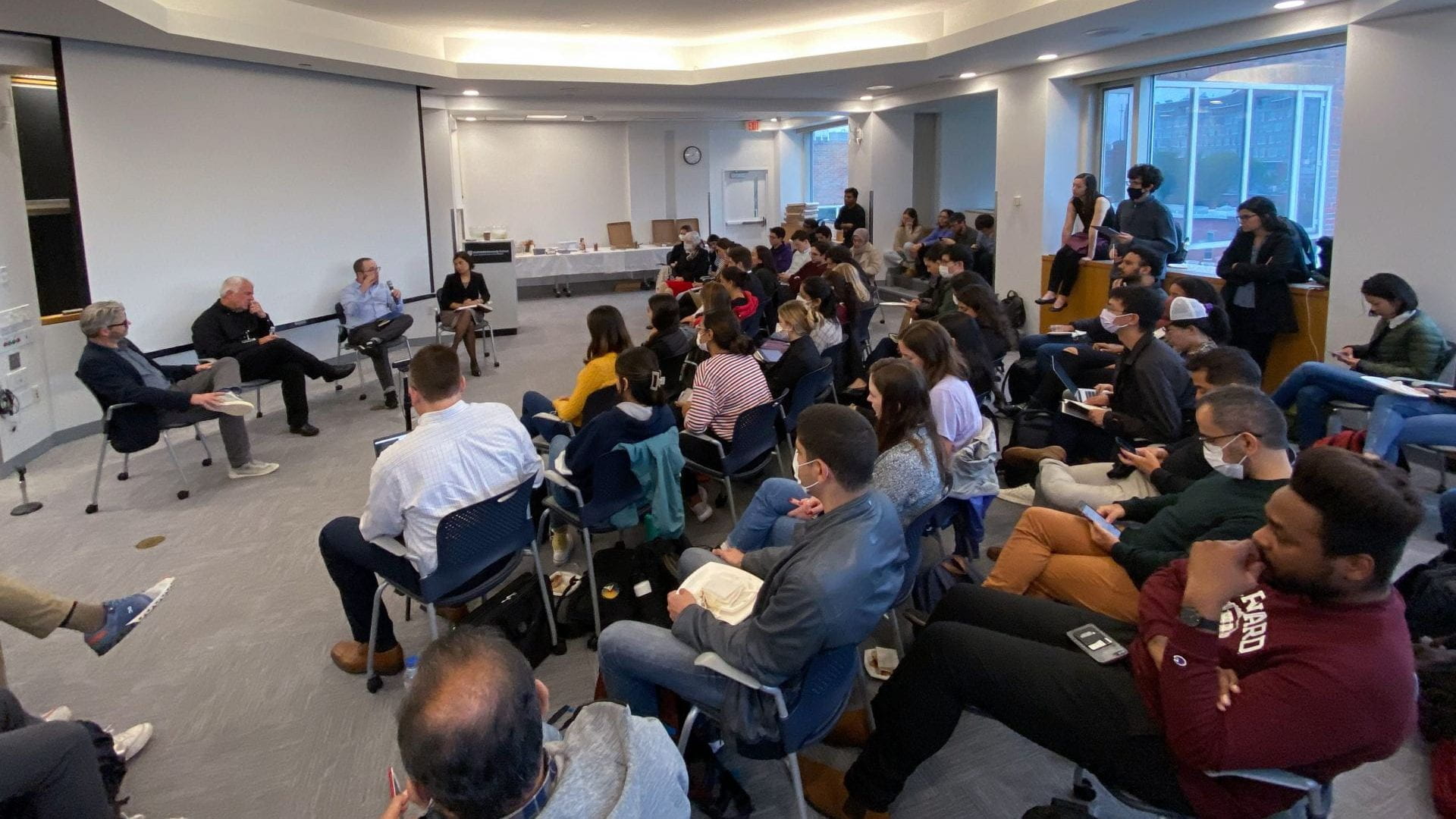 Matt Andrews, Lant Pritchett, Dan Honig, and Salimah Samji presenting in front of a group of students