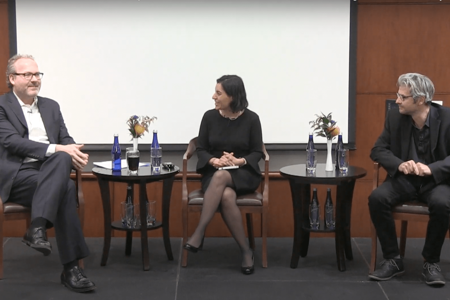 From left to right: Jorrit de Jong, Salimah Samji, and Matt Andrews sitting on a panel in a conference room