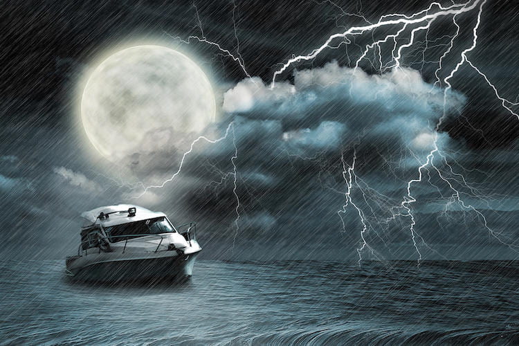 A boat at night with the moon behind it and lightning passing through a cloud