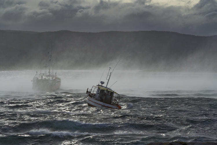 2 boats on misty stormy waters