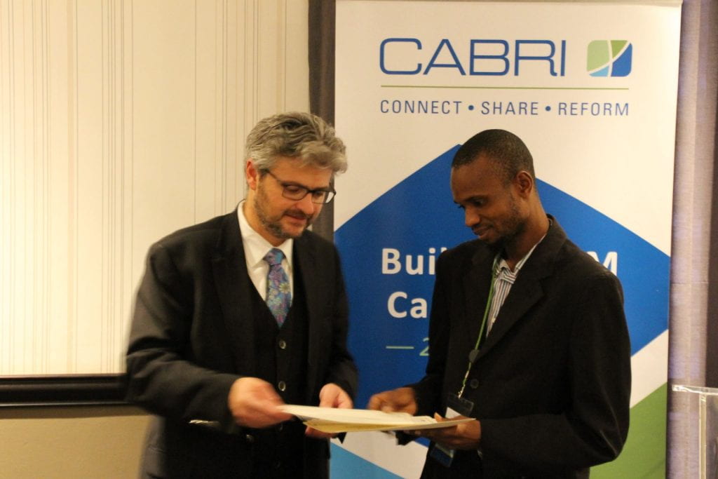 Matt Andrews giving a participant a certificate