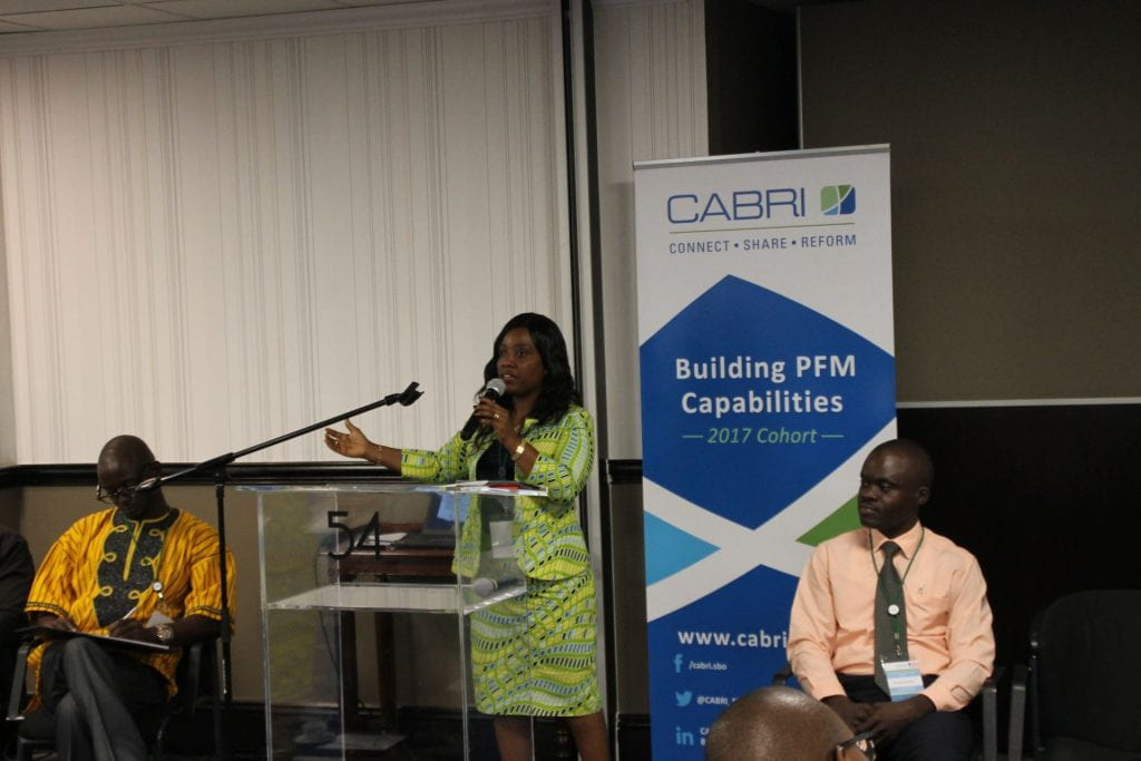 Liberia participant presenting with teammates on either side