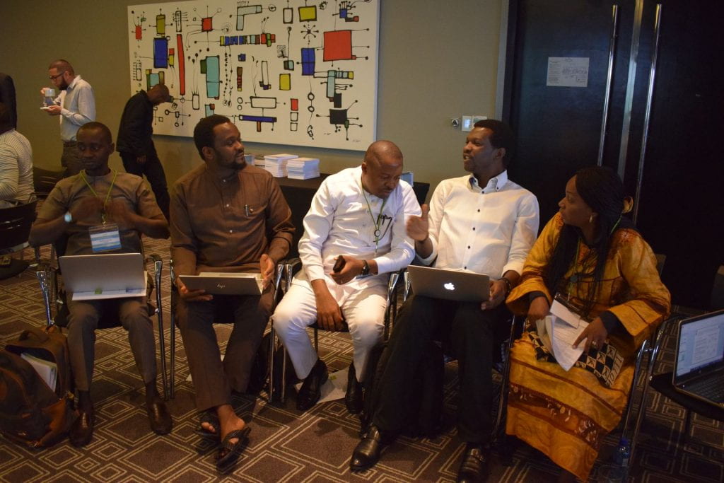 Nigeria team collaborating and using laptops