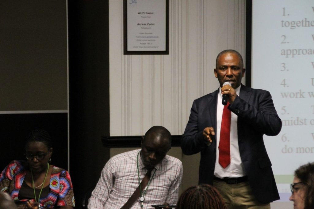 Sierra Leone participant presenting with teammates on either side