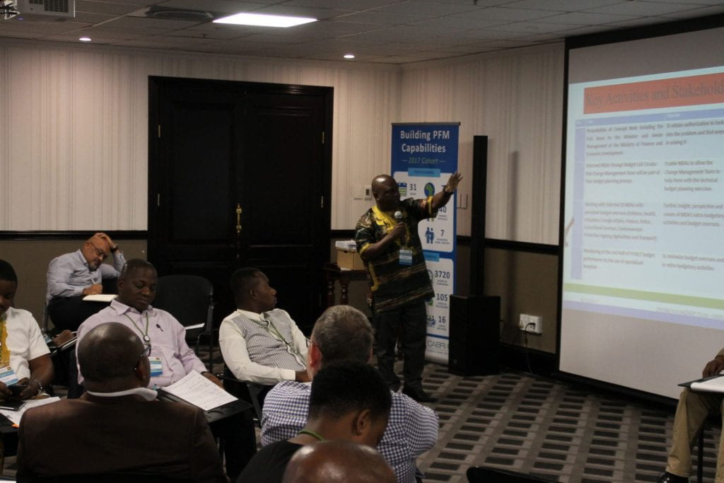 Sierra Leone participant presenting and pointing to the slide projection