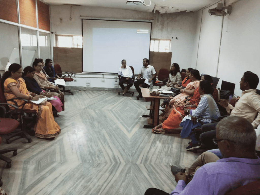 A group of participants in discussion in a conference room