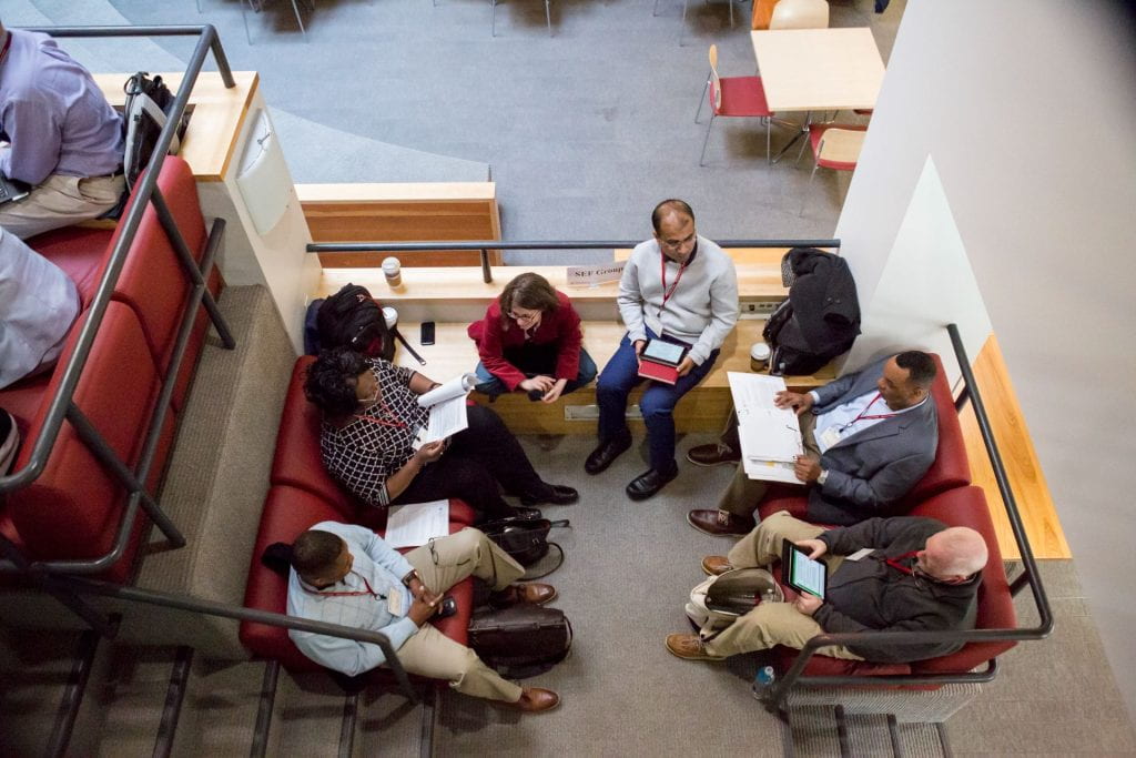 Aerial vantage point of men and women seated in a circle