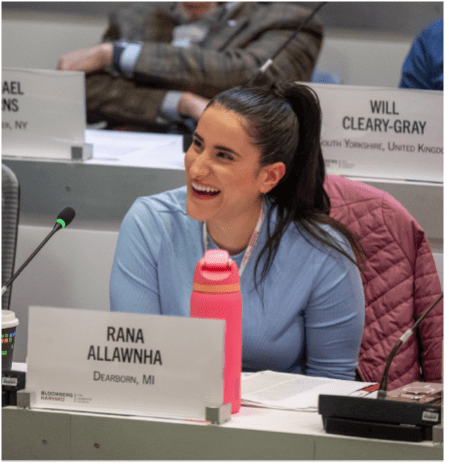 Dearborn team member Rana Allawhna laughing while listening to class presentation