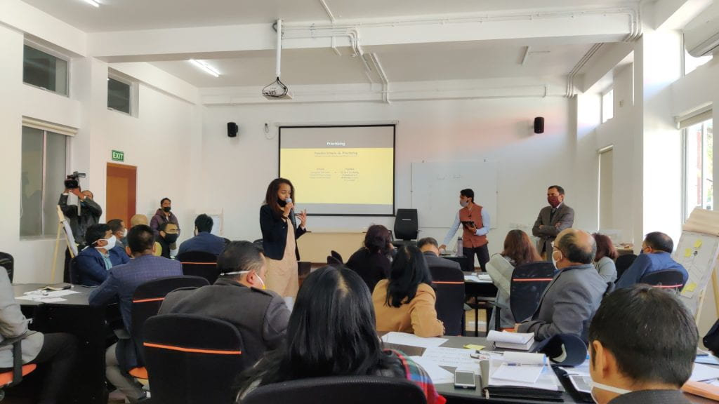 Rebecca and Prateek conducting their first PDIA session with District Collectors in a classroom
