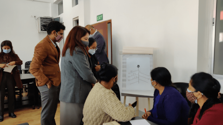 Rebecca and Prateek looking at a group's fishbone diagram