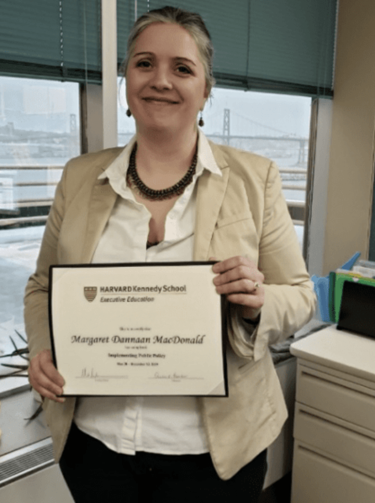 Maggie MacDonald holding HKS certificate
